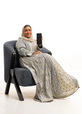 Arab Woman in Traditional Dress Holding Smartphone