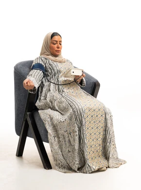 Middle Eastern Woman Measuring Blood Pressure in Studio