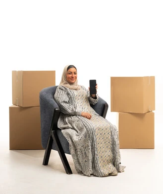 Saudi Woman with Smartphone and Shipping Boxes