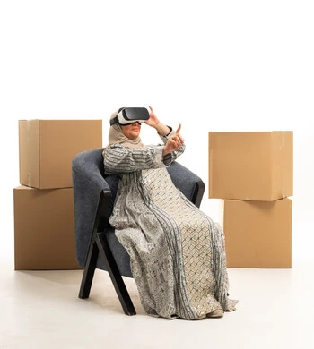 Elderly Arab Woman with VR Headset and Moving Boxes