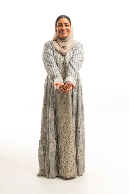 Saudi Woman in Traditional Jalabiya Holding Agarwood Oud