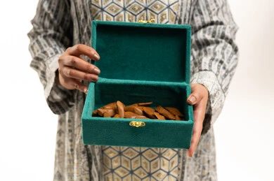 Arabian Woman Holding Oud Agarwood in Green Box