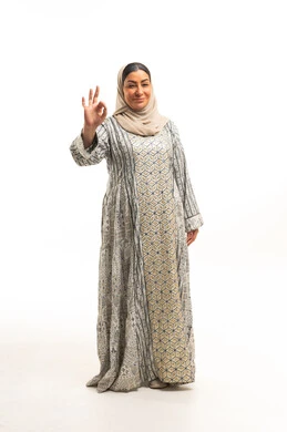 Saudi Woman in Traditional Jalabiya Making OK Gesture