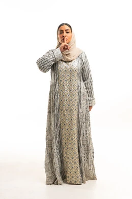 Emirati Woman in Traditional Dress Silence Gesture