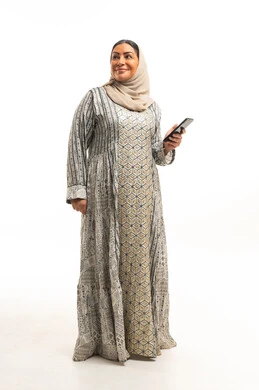 Arab Woman in Traditional Jalabiya Holding Smartphone