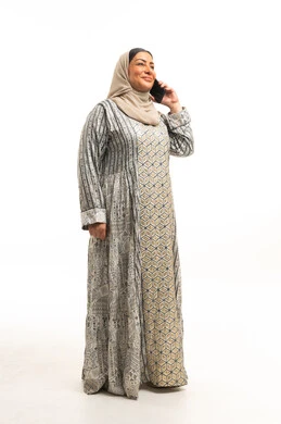 Emirati Woman in Traditional Jalabiya Using Smartphone