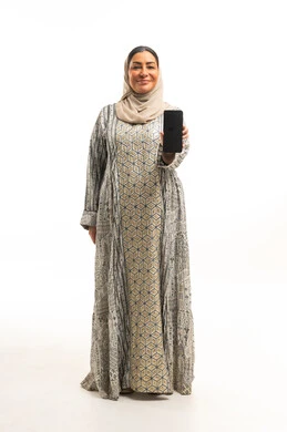 Arab Woman in Jalabiya Holding Smartphone White Background