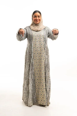 Saudi Woman in Jalabiya Pointing Down White Background