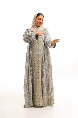 Emirati Woman in Patterned Jalabiya Pointing at Hand