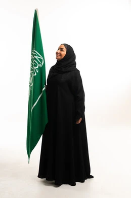 Saudi Woman in Abaya with Saudi Arabia National Flag