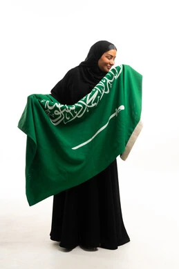 Saudi Woman Holding National Flag in Studio