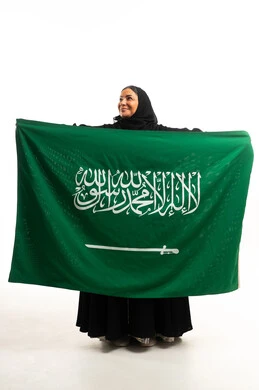Saudi Woman with National Flag in Studio Background