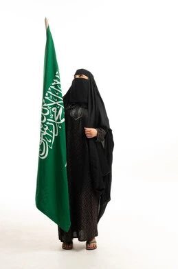 Saudi Woman in Traditional Abaya Holding Saudi Flag