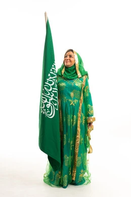 Saudi Woman in Traditional Dress Holding National Flag