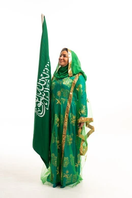Saudi Woman in Traditional Green Dress with National Flag