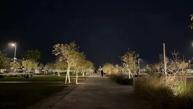 Ahmed Al Mousa Park Pathway with Trees and Night Lighting