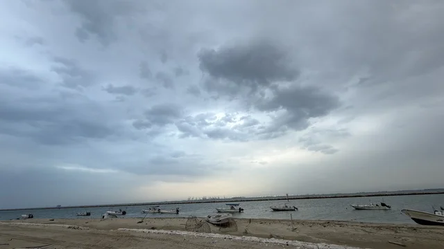 Dammam Ship Corniche with Fishing Boats Under Cloudy Sky