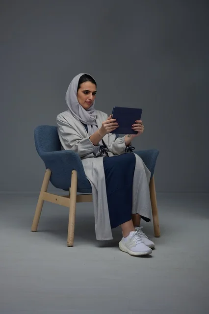 Saudi Woman Using Tablet in Studio Setting