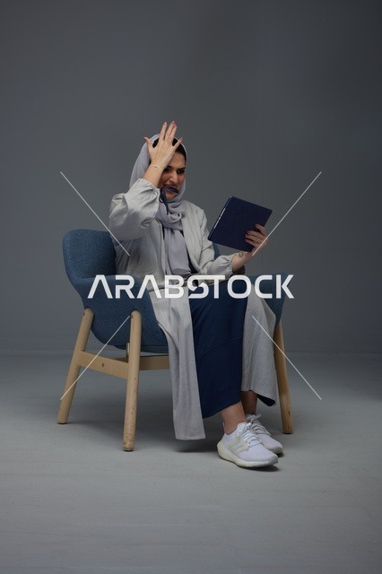 امرأة سعودية تستخدم جهاز لوحي برد فعل متعجب