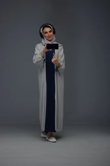 Saudi Woman with Headphones and Smartphone in Studio