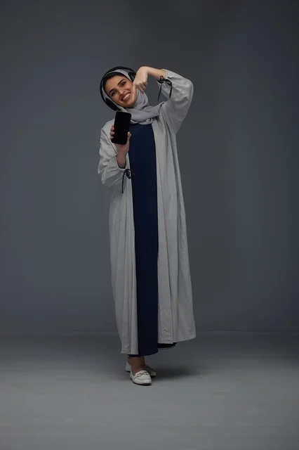 Saudi Woman with Smartphone and Headphones in Studio