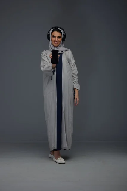 Saudi Woman with Headphones and Smartphone in Studio