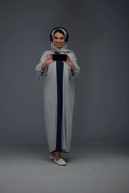 Saudi Woman with Headphones and Smartphone in Studio