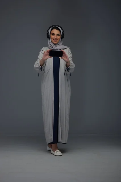 Saudi Woman with Headphones and Smartphone in Studio