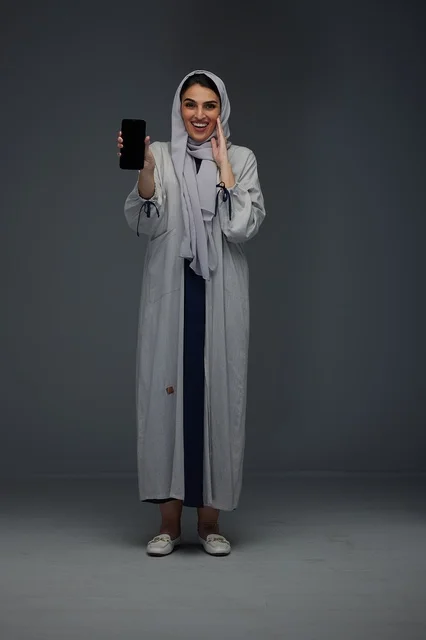 Smiling Saudi Woman Holding Smartphone Blank Screen