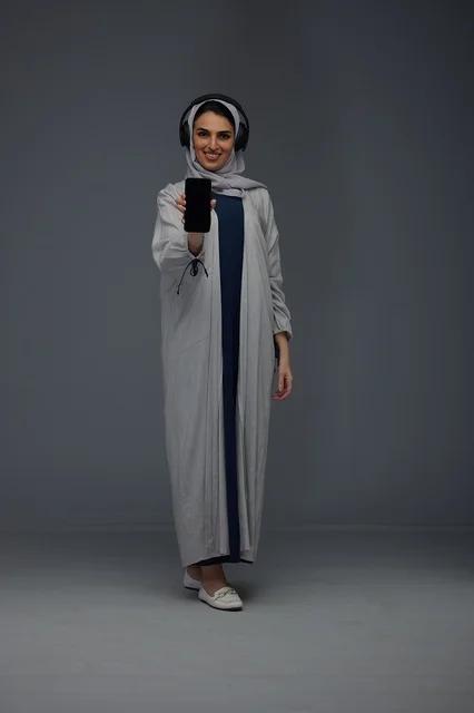Saudi Woman with Headphones and Smartphone in Studio