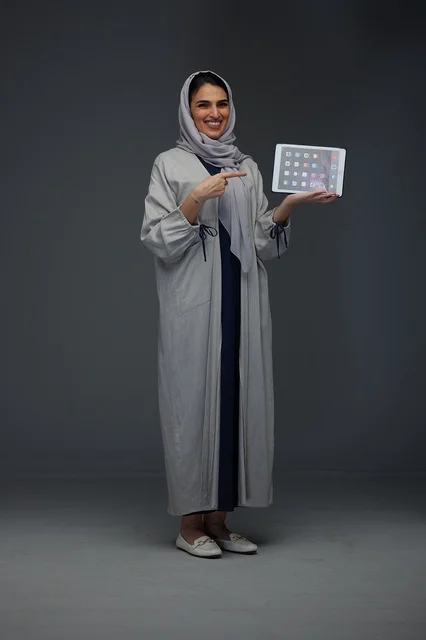 Saudi Woman Holding Tablet Computer in Studio