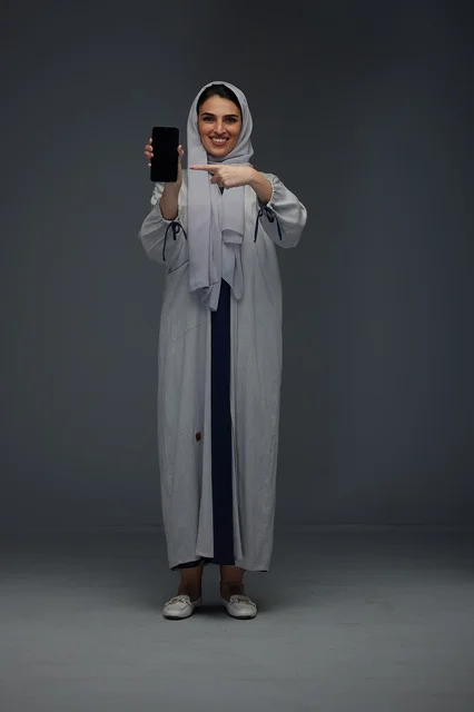 Saudi Woman Pointing at Blank Smartphone Screen