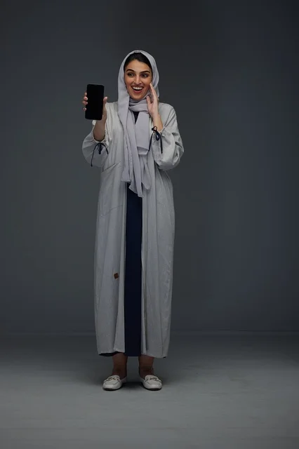 Saudi Woman Holding Smartphone with Blank Screen