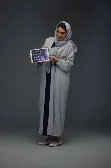 Saudi Woman Holding Tablet Device in Studio