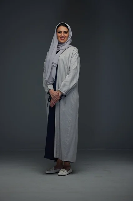 Saudi Woman in Grey Abaya on Studio Background