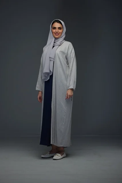 Smiling Saudi Woman in Grey Abaya Standing in Studio Smiling Saudi Woman in Grey Abaya Standing in Studio