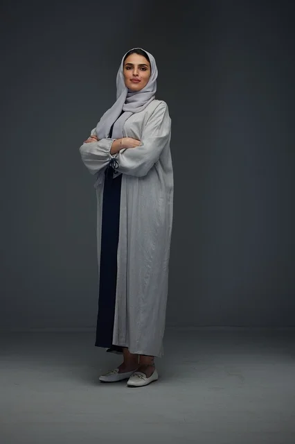 Saudi Woman in Grey Abaya Standing in Studio Portrait