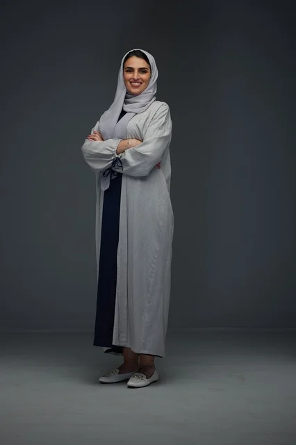 Saudi Woman in Grey Abaya Standing in Studio