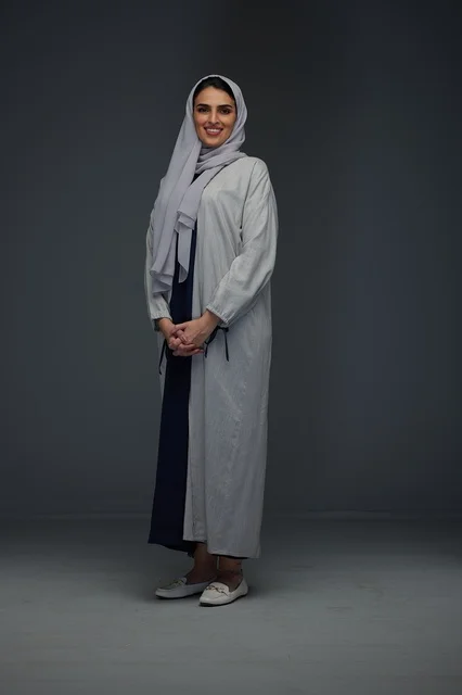 Saudi Woman in Grey Abaya Standing in Studio Portrait