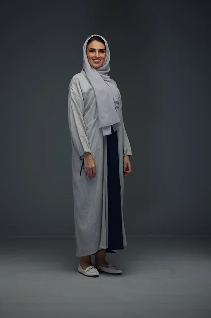 Saudi Woman in Grey Abaya Standing in Studio Portrait