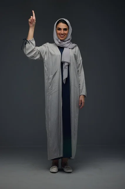 Saudi Woman in Grey Abaya Pointing Upwards