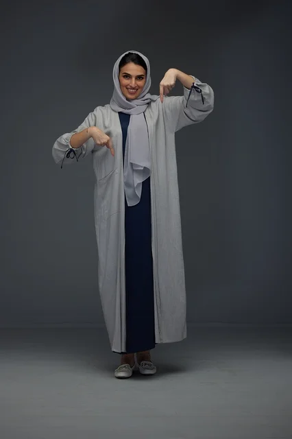 Saudi Woman in Grey Abaya Pointing Down in Studio