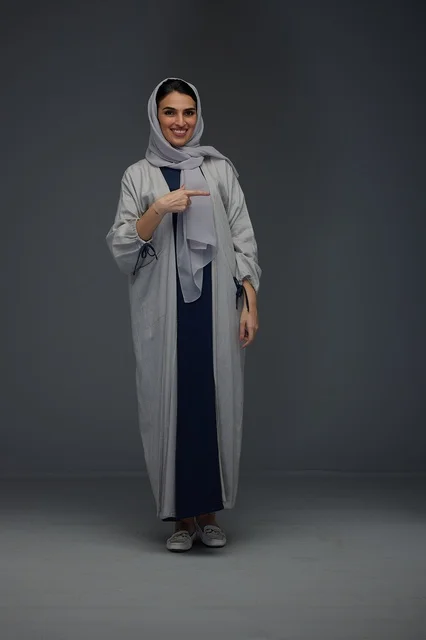 Saudi Woman in Grey Abaya Pointing at Camera
