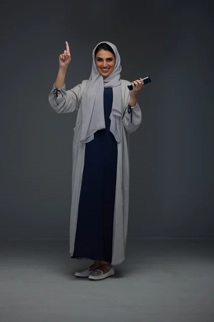 Saudi Woman with Smartphone Pointing Up Studio