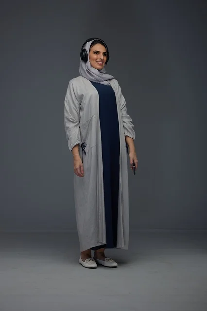 Saudi Woman Wearing Headphones and Abaya in Studio