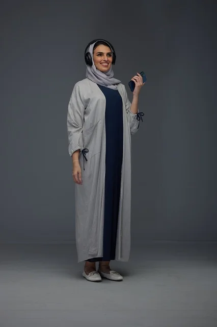 Saudi Woman with Headphones and Smartphone in Studio