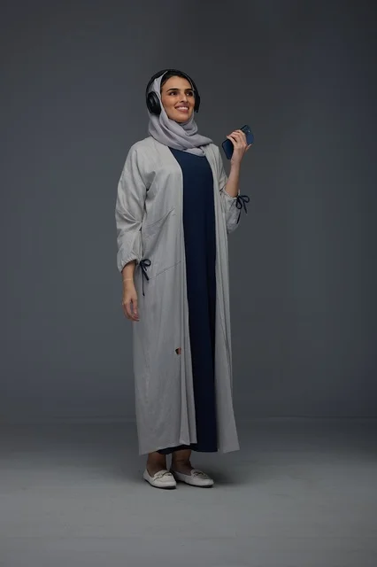Saudi Woman with Headphones and Smartphone in Studio