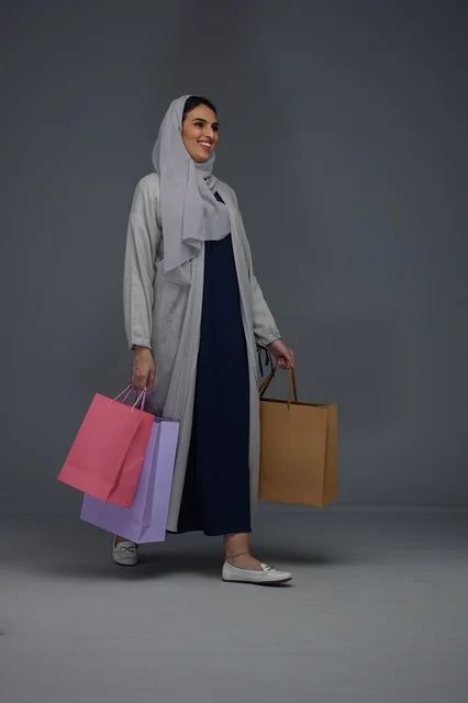 Saudi Woman Walking with Colorful Shopping Bags Saudi Woman Walking with Colorful Shopping Bags