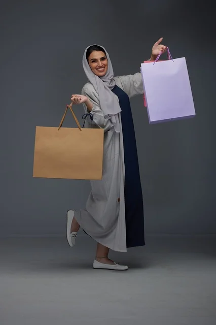 Saudi Woman Holding Shopping Bags in Studio Portrait