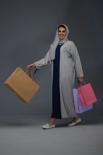 Saudi Woman with Shopping Bags in Studio Setting